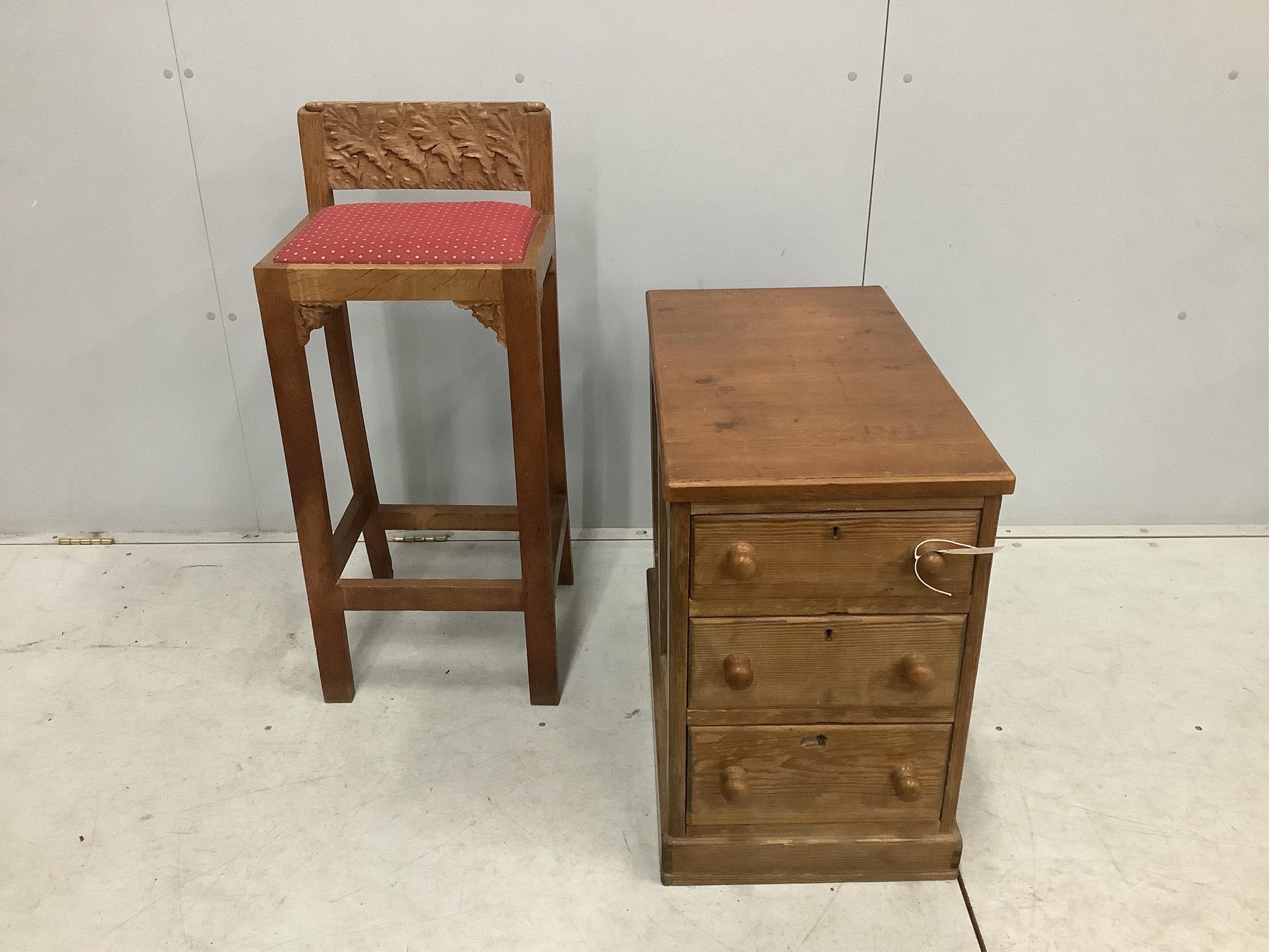 An Arts & Crafts oak clerk's chair, width 38cm, depth 31cm, height 90cm, together with a pine three drawer pedestal chest. Condition - fair